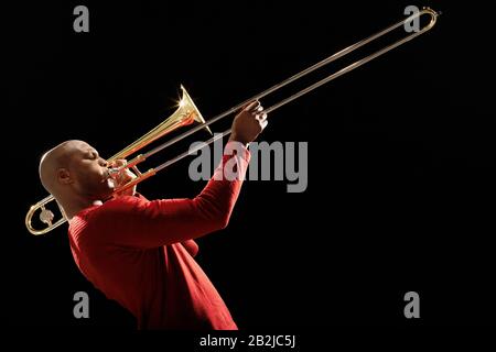 Man Playing Trombone side view Stock Photo