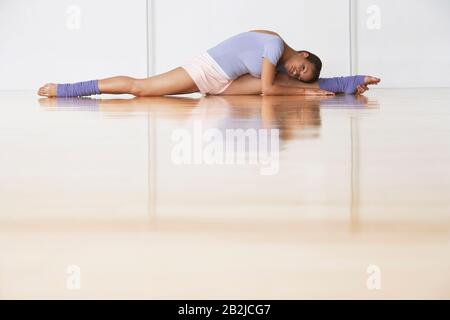 Dancer Stretching Before Rehearsal Stock Photo