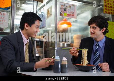 Two business men having lunch in Chinese bar Stock Photo