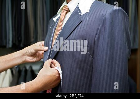 Tailor Fitting Man in Suit Stock Photo
