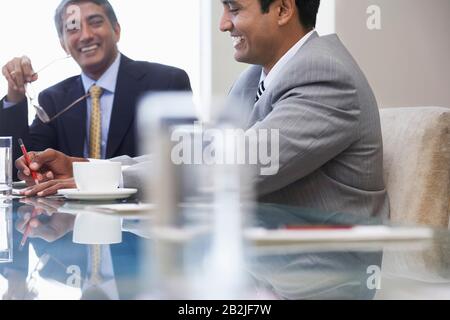 Business associates laughing on business meeting Stock Photo