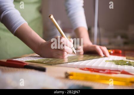 Craftswoman marking glass Stock Photo