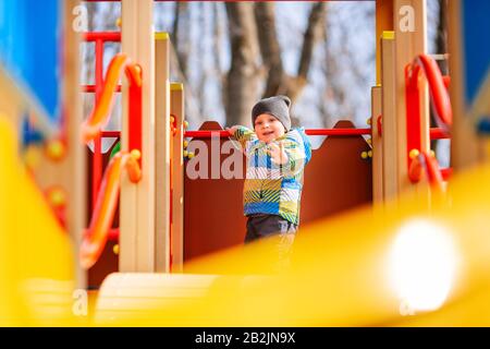 Happy little baby boy playing on the playground outdoor Stock Photo