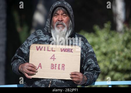 Portrait of senior homeless man with placard Stock Photo