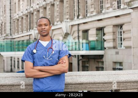 Portrait of a confident African American male surgeon standing with arms crossed Stock Photo