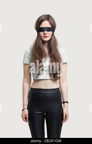 Young Woman Wearing Black Blindfold Isolated On Grey Stock Photo, Picture  and Royalty Free Image. Image 114818746.