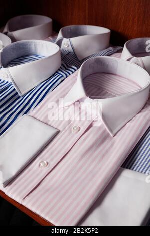 Folded shirts on shelf in a clothing store Stock Photo