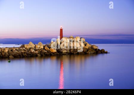 Lighthouse In The Night Very Long Exposure With Medium Telephoto Lens On Tripod Mounted Camera Stock Photo