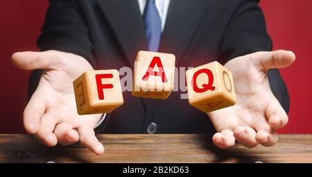 Cubes thrown by a official make word abbreviation acronym FAQ (frequently asked questions). Instructions rules. Convenient form of answers explanation Stock Photo