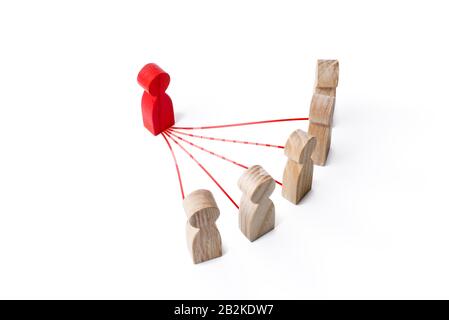Red leader figurine connected with people by lines. Leadership and communication. Building a model of relationship with subordinates. Optimization and Stock Photo