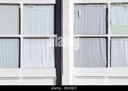 a pair of old vintage pane glass windows on a white building Stock Photo