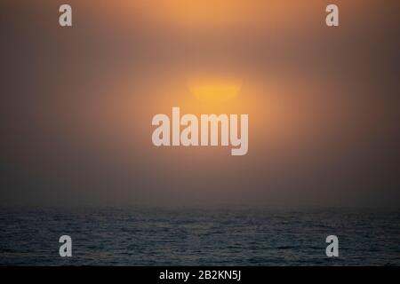Cloudy Sunset over the ocean Stock Photo