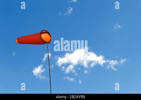 Airfield windsock, used to indicate wind speed and direction, shown ...