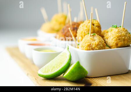 Various mini chicken kievs and sweet potato falafels served with sauces, banquet food Stock Photo