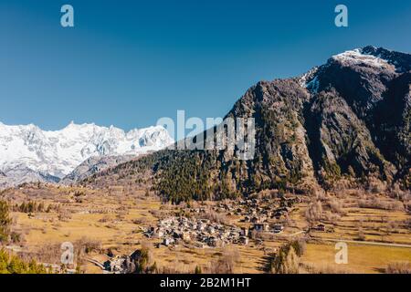 The village Palleusieux under a big mountain, in the Basin Pre-Saint-Didier, Aosta Valley, Italy Stock Photo