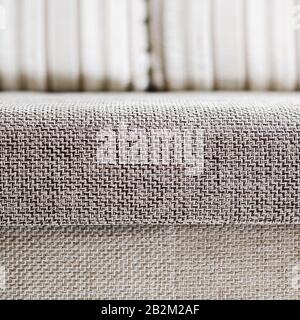 Closeup of a fragment of a beige textile sofa in the room. Texture of expensive fabric on furniture. Sofa element couch couch room furniture Stock Photo