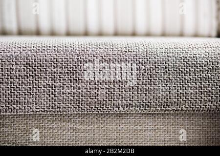 Closeup of a fragment of a beige textile sofa in the room. Texture of expensive fabric on furniture. Sofa element couch couch room furniture Stock Photo