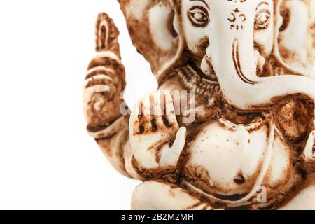 Hindu god Ganesh on a black background. Statue with incense smoke aromo sticks. Copy space Stock Photo