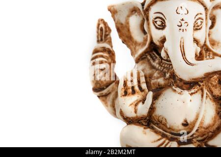 Hindu god Ganesh on a black background. Statue with incense smoke aromo sticks. Copy space Stock Photo