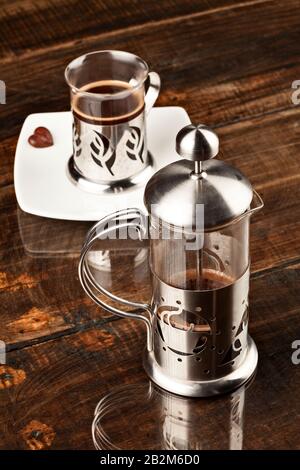 Classic Cafe Cup Served Along With Screen Against Overweight Polished Wooden Table Stock Photo