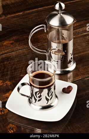 Elegant Cafe Cup Served Along With Filter Against Overweight Polished Wooden Table Stock Photo