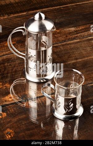 Fancy Caffeine Cup Served Along With Screen Against Durable Polished Wooden Table Stock Photo