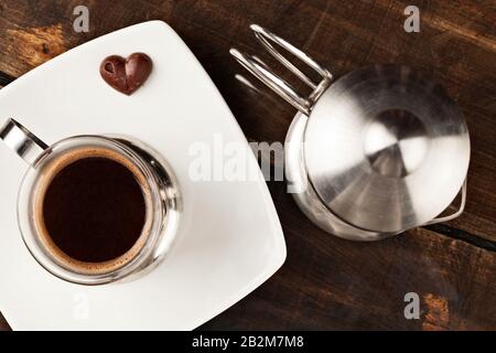 Elegant Coffee Cup Served Along With Filter Against Heavy Polished Wooden Table Stock Photo