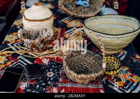 Different hand made weave basckets on table. Craft workshop. Close up shot. Stock Photo
