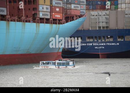 Hamburg, Deutschland. 17th Feb, 2020. A barge of the harbor tour in front of the container ship Elly Maersk at the container terminal Eurogate, behind it the CMA CGM Benjamin Franklin, Hamburg Waltershof February 17, 2020. | usage worldwide Credit: dpa/Alamy Live News Stock Photo