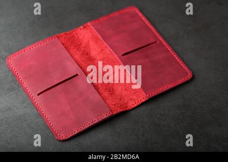Open the red leather cover for your passport. Genuine leather, handmade. Close stitching, top view Stock Photo