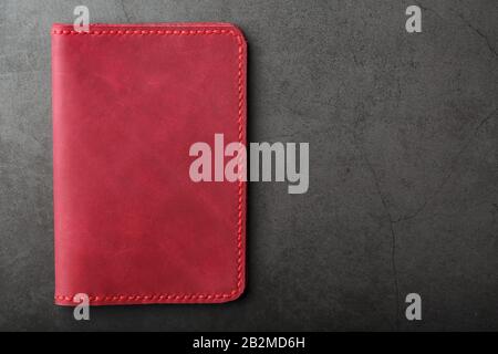 Red and pink leather cover in the background of tools and materials. The view from the top Stock Photo