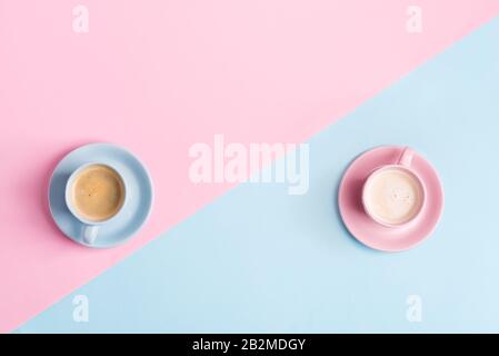 Decorative composition from two ceramic cups of freshly brewed aromatic coffee drink on a pastel blue pink background . Flat lay. Stock Photo