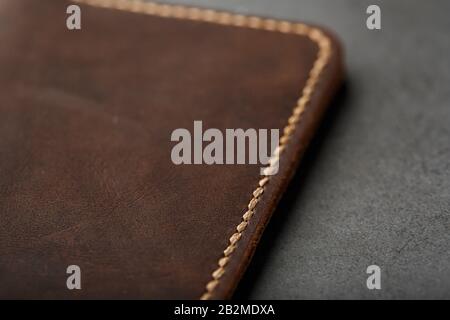 Dark Brown Leather Passport Cover. Genuine leather, handmade. Close up stitching Stock Photo