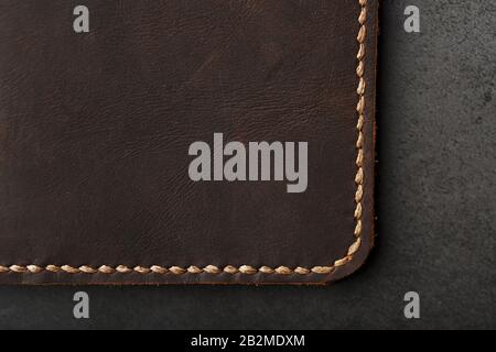 Dark Brown Leather Passport Cover. Genuine leather, handmade. Close up stitching Stock Photo