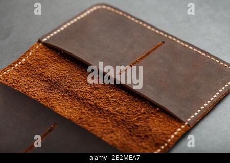Open Dark Brown Leather Passport Cover. Genuine leather, handmade. Close up stitching, View from above Stock Photo