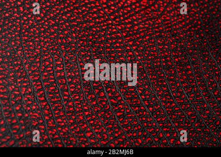 Red - black textured reptile skin, used texture for the background. Lizard or crocodile skin. Freshwater crocodile red bone skin texture background. . Stock Photo