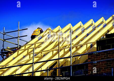 Builder working on wooden roof joists Stock Photo