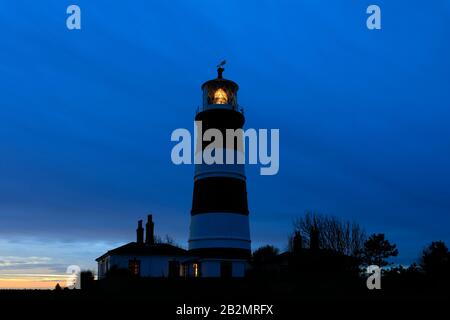 Sunset over Happisburgh Lighthouse, Happisburgh village, North Norfolk Coast, England, UK its the only independently operated lighthouse in the UK. Stock Photo