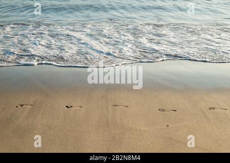 Footprints on the beach sand Stock Photo