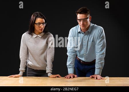 Caucasian businessman and mixed race businesswoman wearing Virtual Reality glasses Stock Photo