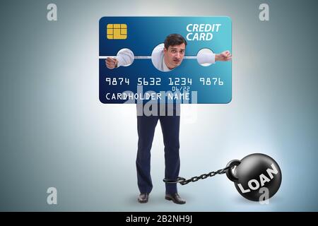 The businessman in credit card burden concept in pillory Stock Photo