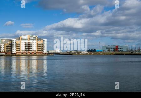 Roath Basin in Cardiff Bay with modern apartment building in the background on a cold March afternoon at Cardiff Bay. Stock Photo