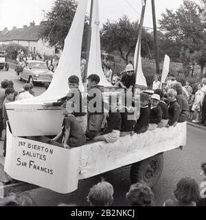 1960s, historical, Cub scouts on a float in a carnival dressed as the boat, 'Gipsy Moth IV', to celebrate the achievements of 'Round-the-World' sailor Sir Francis Chichester, Bierton, Buckinghamshire, England, UK. Chichester became the first person to sail single-handed around the world by the clipper route in nined month and one day in 1966-67. Stock Photo