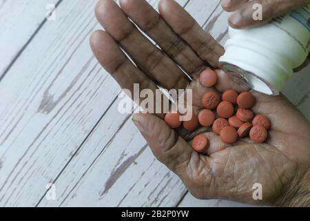 Close up of pain killer on senior women hand  Stock Photo