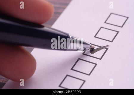 Close up of check mark on white paper  Stock Photo