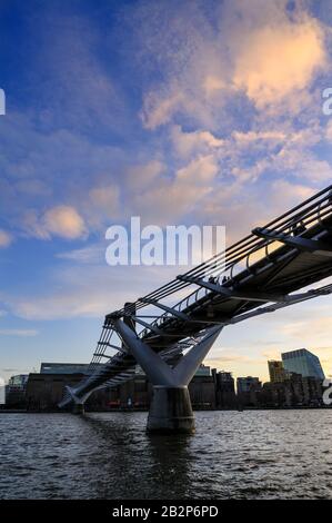 The Millennium Bridge in London, UK crosses the River Thames to the Tate Modern gallery with Blackfriars Bridge and the South Bank behind Stock Photo