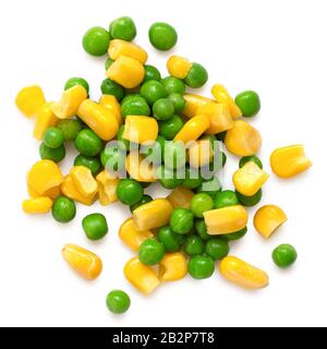 Spilled fresh green garden peas and sweetcorn isolated on white. Top view. Stock Photo