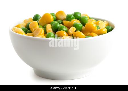 Fresh green garden peas and sweetcorn mix in a white ceramic bowl isolated on white. Low angle. Stock Photo