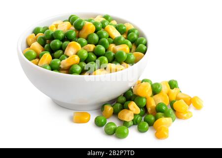 Fresh green garden peas and sweetcorn mix in a white ceramic bowl isolated on white. Spilled peas and sweetcorn. Stock Photo