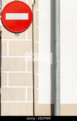 Red circular no entry sign on wall with painted 3D effect and pipe, Guia de Isora, Tenerife, Canary Islands, Spain Stock Photo